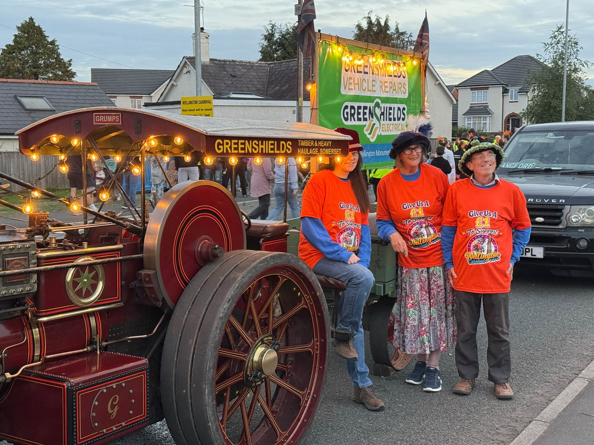 The team beside the steam engine with the Greenshields banner behind