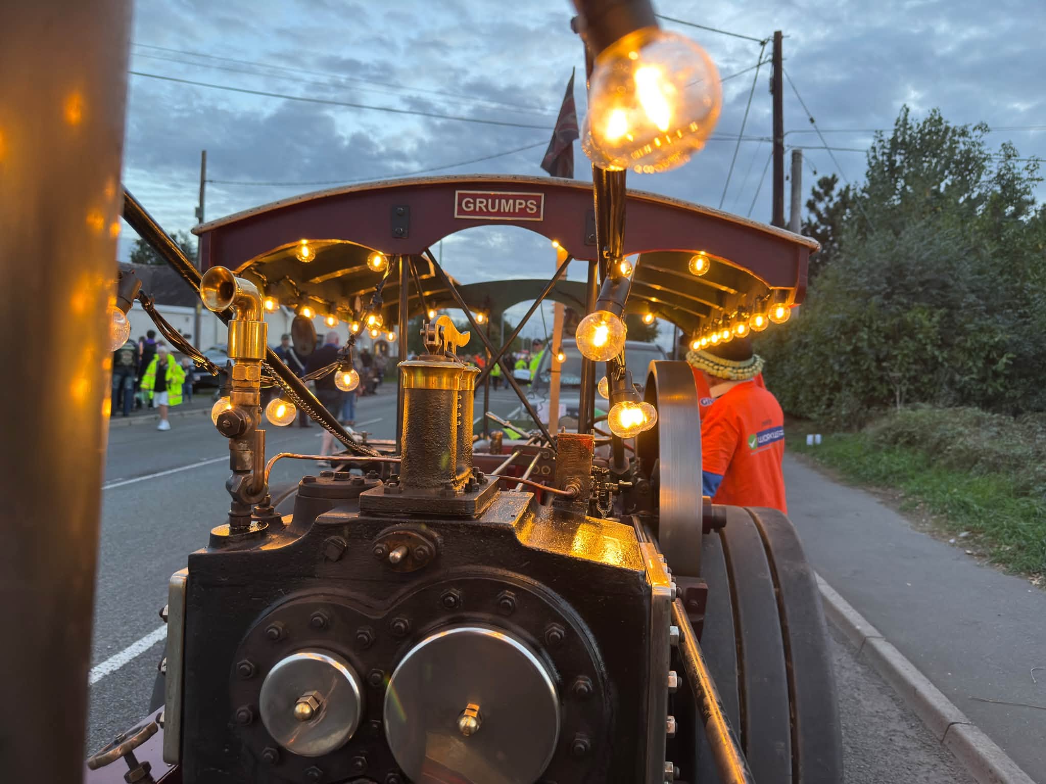 The front of the steam engine lit with festoon bulbs